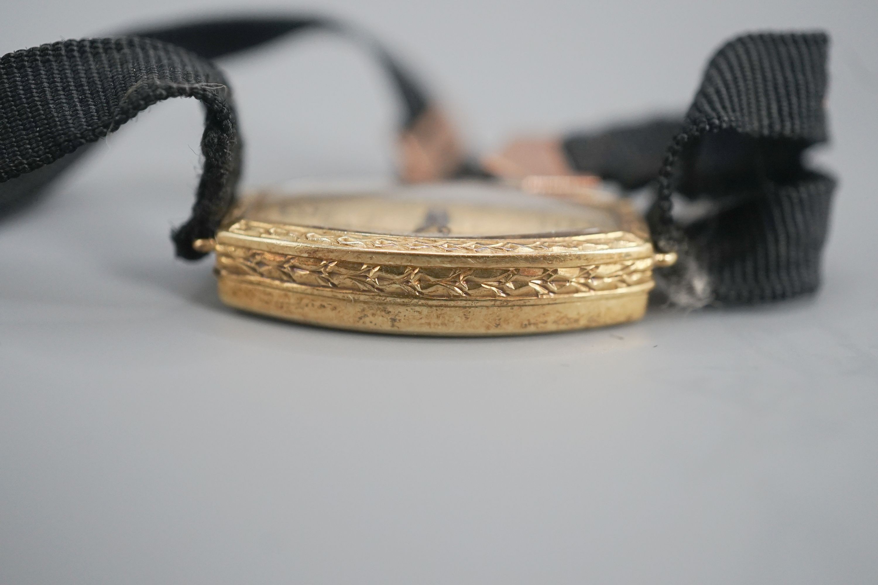 A lady's early 20th century 18ct gold manual wind wrist watch, case diameter 17mm, on a sash strap with 9ct buckle